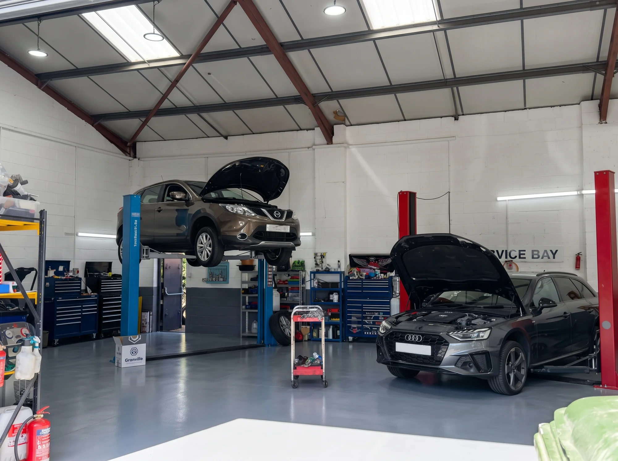 The service bay at Bond Street Garage, cars on the lifts